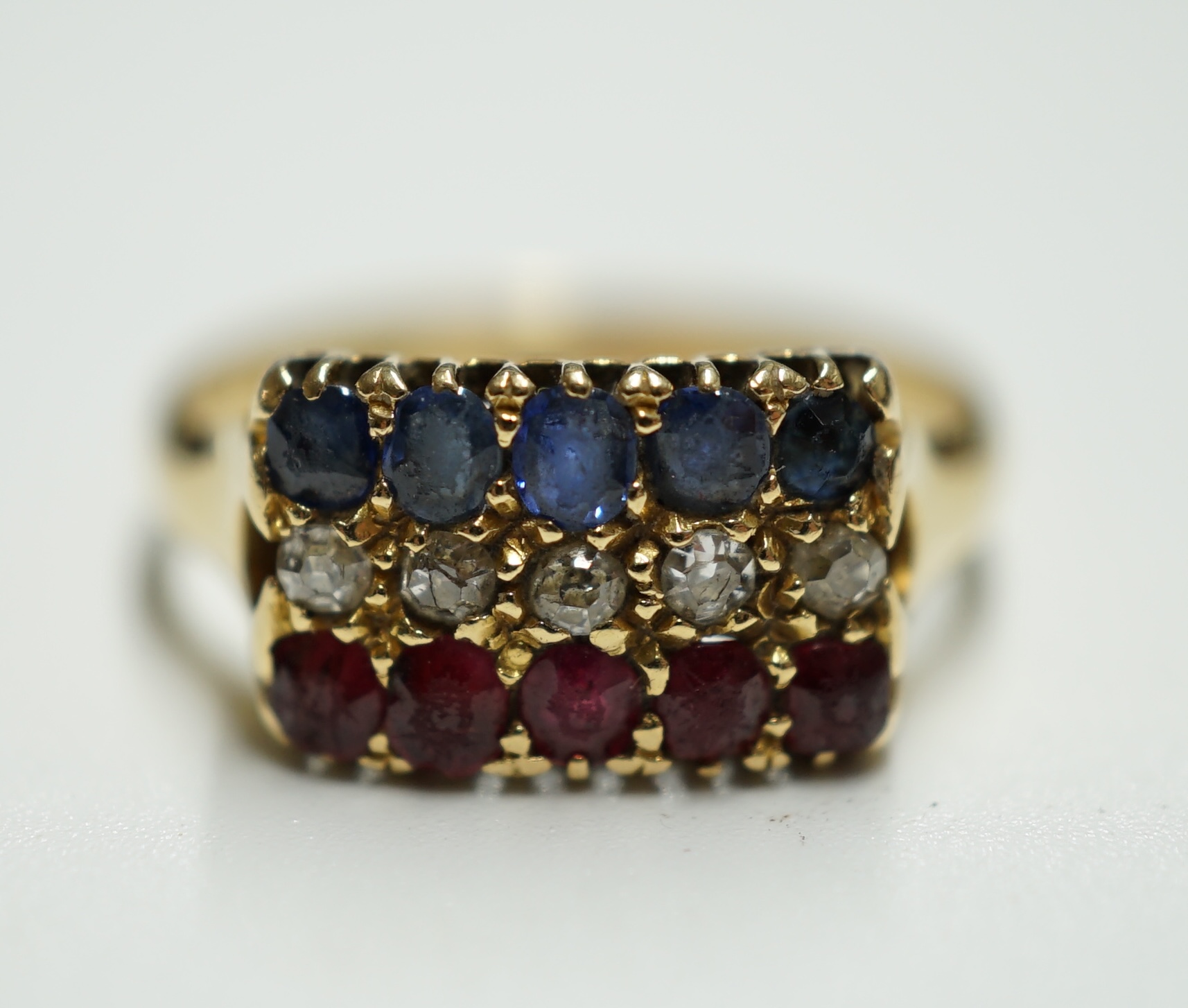 An early 20th century gold and three row sapphire, ruby and diamond set ring, size M, gross weight 3.1 rams. Condition - poor to fair